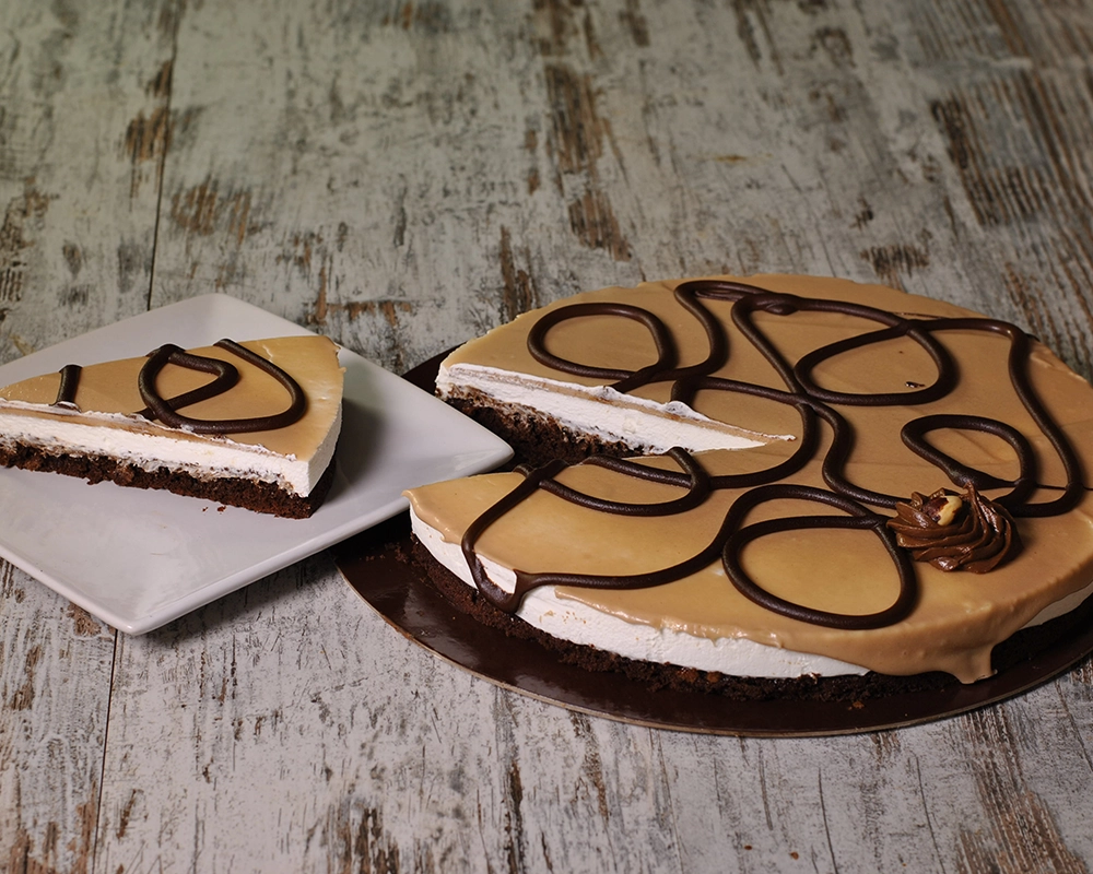Tarta Ferrero con una porción servida en plato, sobre madera